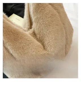 Close-up of the plush khaki faux fur texture and metal zipper detail of this tote bag