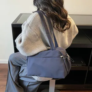 Minimalist navy blue nylon tote bag with zipper pocket for daily commute and fitness