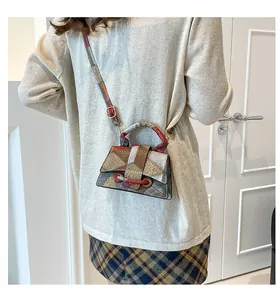 Detail of the vintage geometric color-block shoulder bag with flap and metal lock