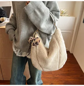 Detail of plush off-white faux fur hobo bag with a stylish leopard print heart charm