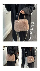 Detail of khaki faux fur bag with decorative large pearls and metallic chain strap