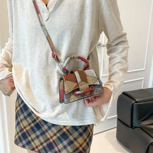 Vintage patchwork crossbody bag with textured leather panels and round handle decoration