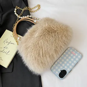 Detail showing plush handbag texture with decorative gold chain and white pearls