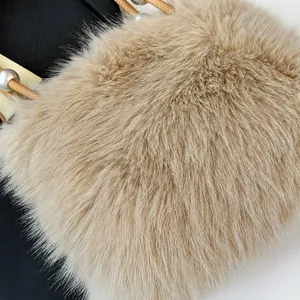 Detailed macro view of soft plush faux fur texture with elegant pearl chain handle detail
