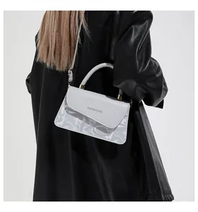 Détail du sac à main en cuir PU gris clair avec lettres embossées et bandoulière