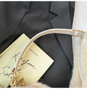 Detail view of plush beige tote bag featuring gold hardware and premium faux fur texture