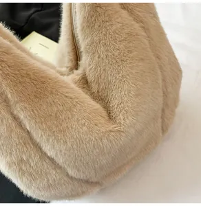 Close-up of the plush faux fur texture and camel color of the luxury tote handbag