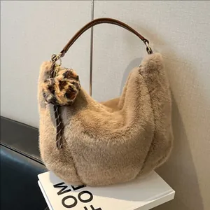 Plush beige faux fur hobo bag with leather handles and leopard print charm accessory