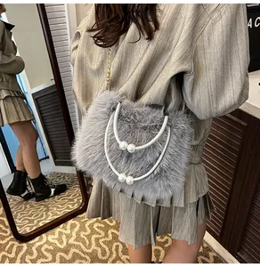 Close-up of grey fluffy faux fur shoulder bag with pearl handle and golden chain strap