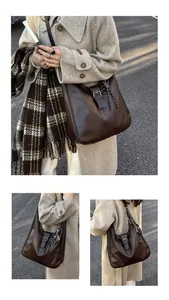 Detail view of brown vintage faux leather tote with buckle accent and strap textures
