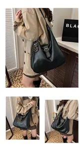 Detail of black vintage hobo bag featuring wax leather texture and wooden pendant