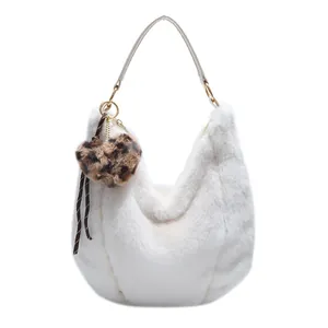 White faux fur tote bag with leather handle and leopard print heart charm for winter fashion