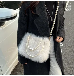 Detailed close-up of white plush shoulder bag featuring elegant pearl chain and soft faux fur