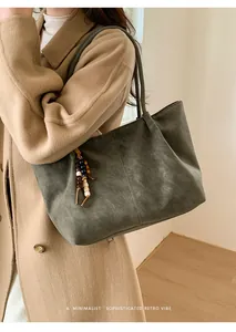 Close-up of retro large-capacity tote bag in frosted dark grey with wood bead pendant