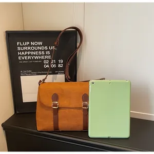Brown matte messenger bag size comparison next to a tablet for daily office commute