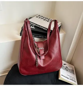 Vintage burgundy hobo bag in wrinkled PU leather with buckle detail on a white step