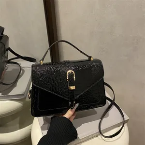 Retro black crocodile pattern handbag with gold clasp and shiny patent leather