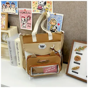 Detail of cute school tote bag with cat-ear shaped pocket and transparent PVC insert