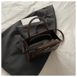 Top view of the deep brown leather handbag with adjustable strap and metal zipper detail
