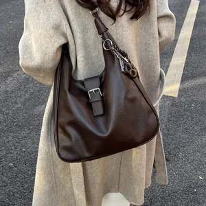 Deep brown large capacity hobo shoulder bag with buckle strap and fringe pendant