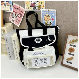 Detail of canvas tote bag with cat-ear window pocket and stylish fashion logo contrast