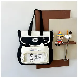 Detail of canvas tote bag showing cat ear flap pocket and transparent insert window