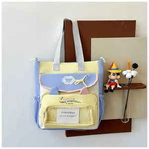 Close-up of color-block tote bag featuring transparent window and cute cat ear design