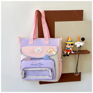 Detail view of colorful canvas bag with cat-ear clear window and fashion branding