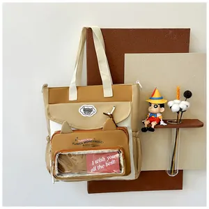 Detail of tote bag featuring a transparent cat-ear window with a red gift card