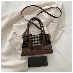 Détail du mini sac seau à carreaux avec patchwork en cuir et doubles poignées