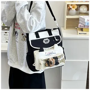 Detail of shoulder bag featuring a cat-ear shaped transparent window with a small plush bear