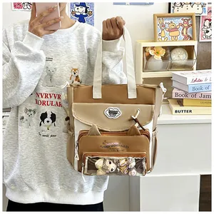 Detail of color-block tote bag featuring clear pocket window with cute cat ear design