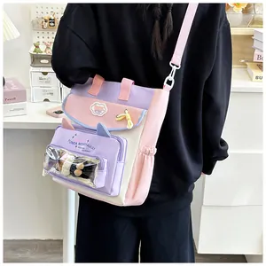 Detail of multi-color tote bag with transparent PVC pocket and plush doll decoration