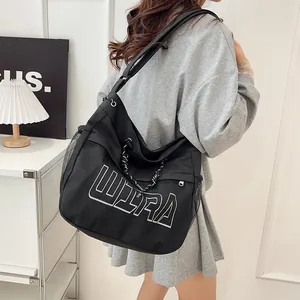 Minimalist black large capacity shoulder bag with ULTRA print and mesh side pocket