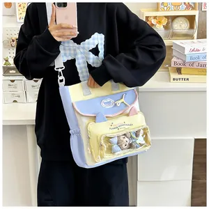 Detail view of colorful canvas ita bag with a clear PVC window and plush toy