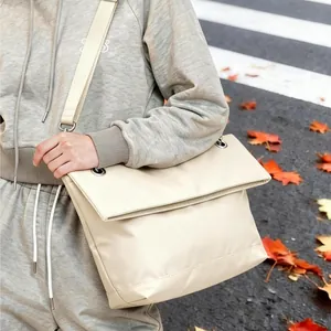 Minimalist beige large tote bag with wide strap for women shown in autumn street scene