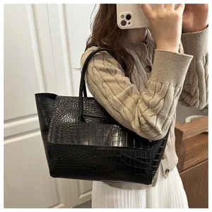 Detail of black crocodile texture tote bag with elegant flap design for commute
