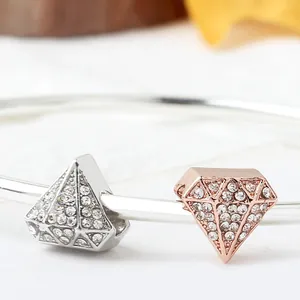 Silver and rose gold diamond-shaped charms with sparkling crystals on a sleek bracelet