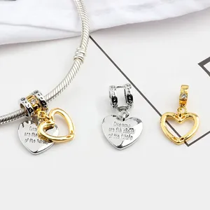Detail of engraved silver heart charm with crystals on a snake chain bracelet
