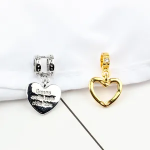 Polished silver and gold heart charms with engraved inspirational quote and zircon inlay