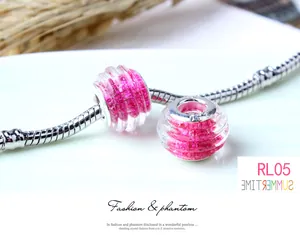 Macro shot of rose pink glitter glass charm bead with S925 core on silver snake chain