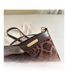 Close-up of leopard print tote bag with brown matte texture and metal fashion plaque