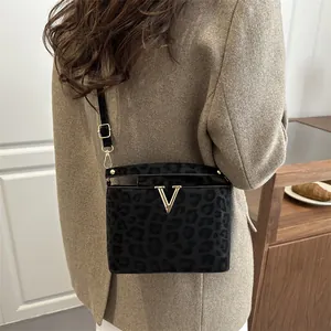 Fashionable leopard print small square bag with gold V-logo and black leather strap