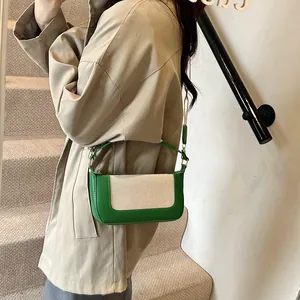 Detail of retro color-block baguette bag with green PU trim and white canvas fabric