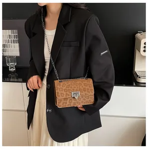 Close-up of leopard print pattern on women flap chain bag with silver buckle