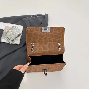 Brown leopard print chain crossbody bag with metallic twist lock and open interior view