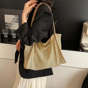 Beige woven straw tote bag with brown leather straps and spacious open design