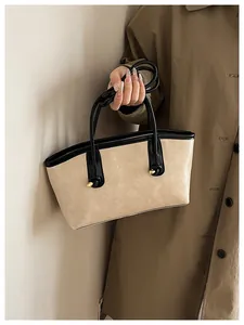 Detail of the beige PU tote bag featuring black leather trim and the FASHION & BAGS logo