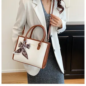 Sac fourre-tout tendance avec foulard porté par un mannequin en blazer blanc et robe grise
