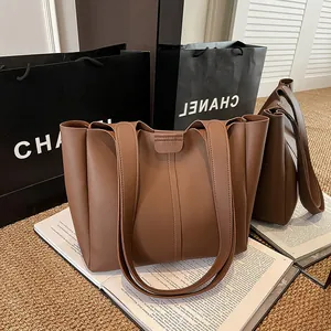 Vintage large brown leather tote bag with pleated design and wide shoulder straps